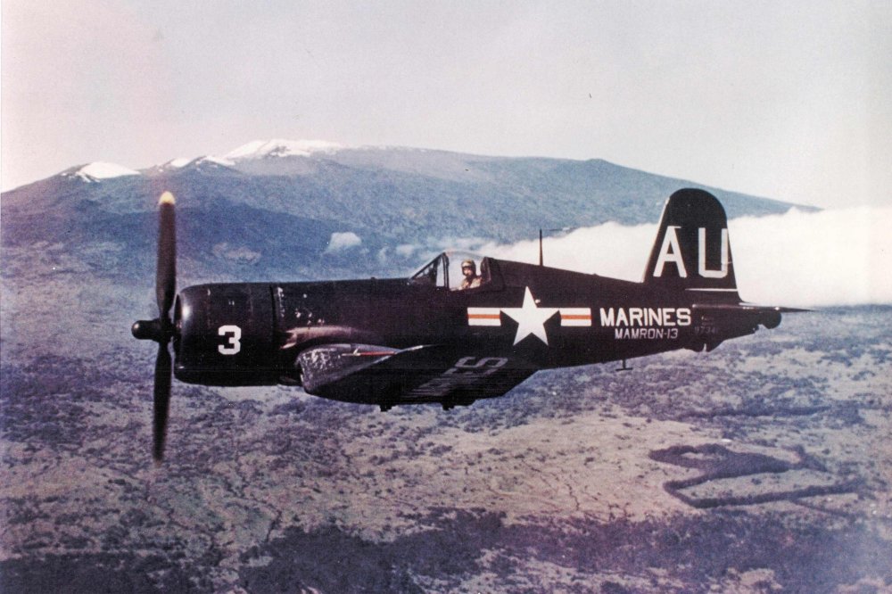 John Mitchell flying Corsair past Mauna Kea taken by Phil Harris 7 May 1953.jpg