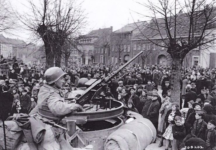 PeopleofJchenGermanylistentoproclamationoftheregulationsforoccupationfromofficersoftheUS2ndArmoredDivision28February1945.jpg.bf1a3346e1227bb2edde94ad641b057d.jpg